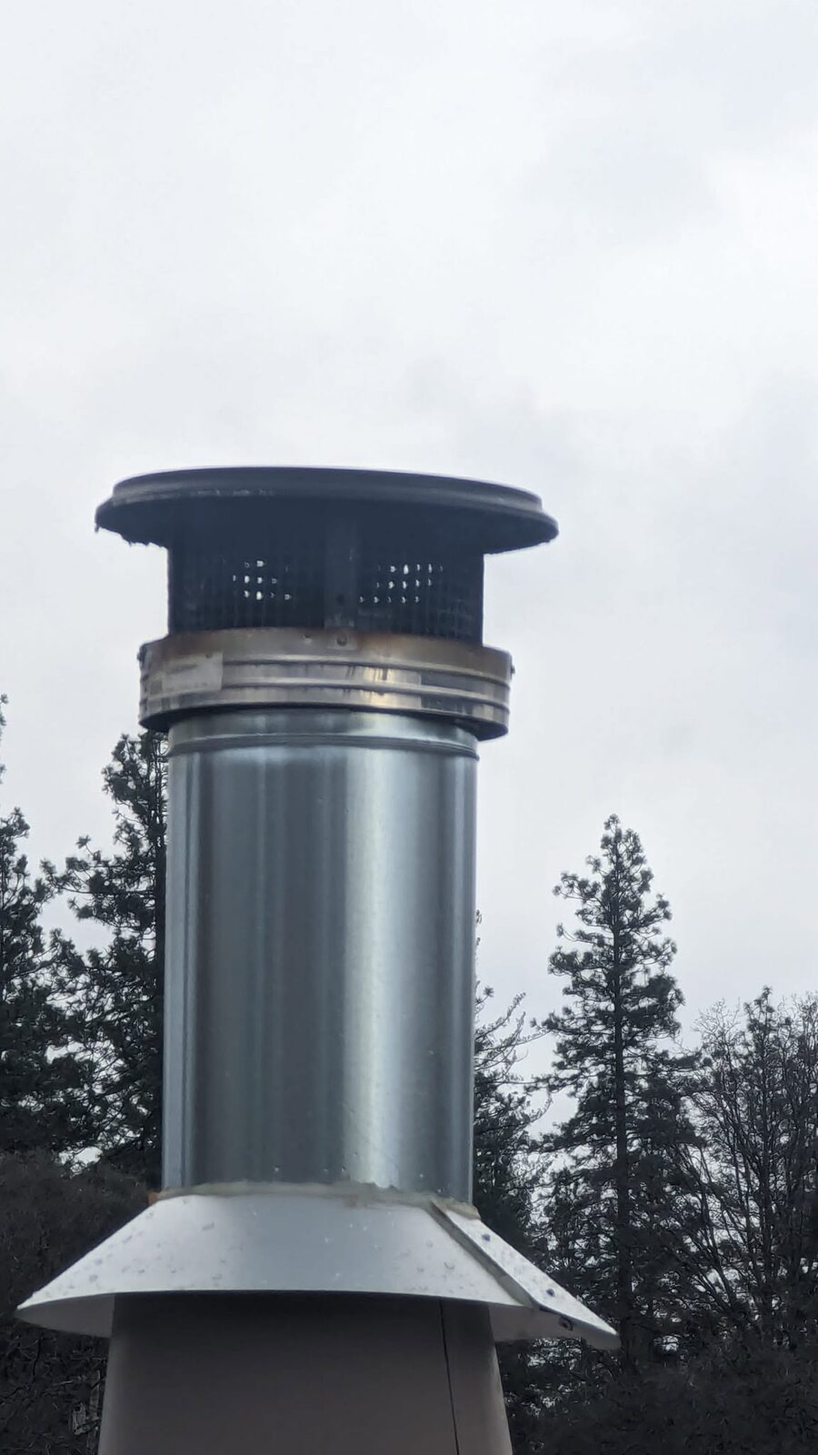 A stainless chimney cap on a metal chase cover