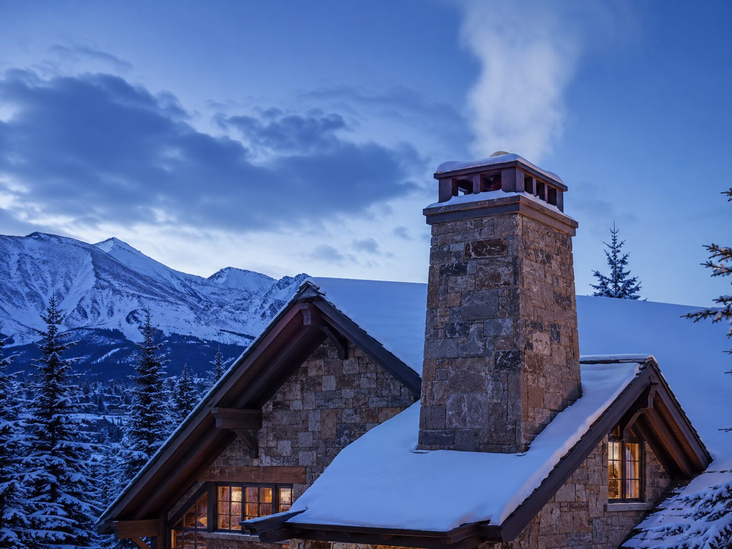 A stone chimney on a Denver-area home at dusk